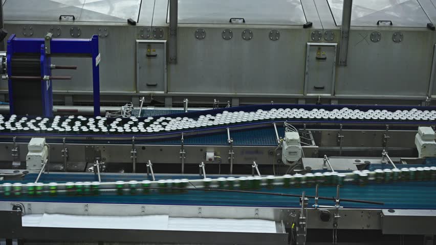 A state-of-the-art beverage factory where countless bottles glide along automated conveyor belts in a spotless production hall. This high-tech facility