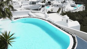 White architecture of Santorini island, Greece. Luxury swimming pool with blue water. Luxury resort. Travel and summer vacation concept
 - Powered by Shutterstock - Get 15% off with code: PIKWIZARD15