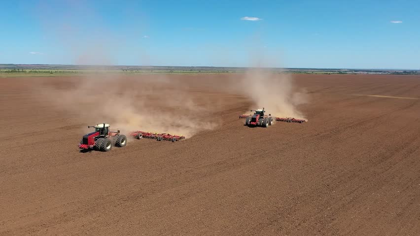 4K. Tractor with a sowing complex works in the field