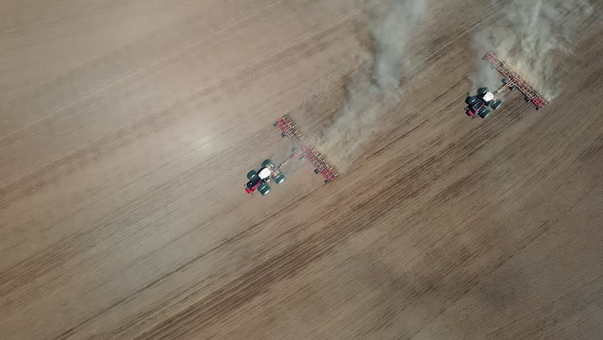 4K. Tractor with a sowing complex works in the field