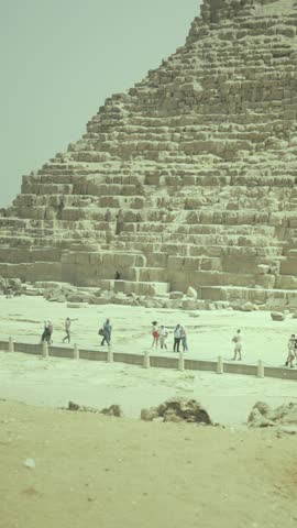 Excursion trip to Egypt pyramids, miracle of the world, view from touristic bus, vertical video. Exploring historical landmarks in Egypt, adventures in Africa, tourists walking at foot of pyramid