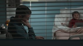 Handheld shot of tired father taking nap in chair while visiting sick daughter playing digital tablet in hospital ward - Powered by Shutterstock - Get 15% off with code: PIKWIZARD15