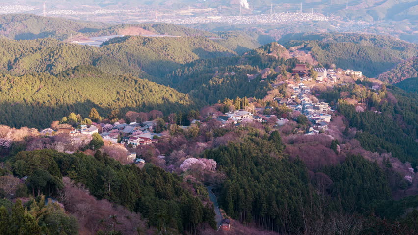 Timelapse viewpoint of Mount Yoshino with traditional village among cherry blossom, sakura tree blooming during springtime at Nara, Japan