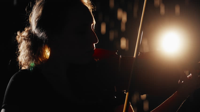 Solo of talented female violinist, romantic night rain and woman in darkness. Express your feelings and emotions by arts and classical music, meditation by sounds of falling water drops, relaxation