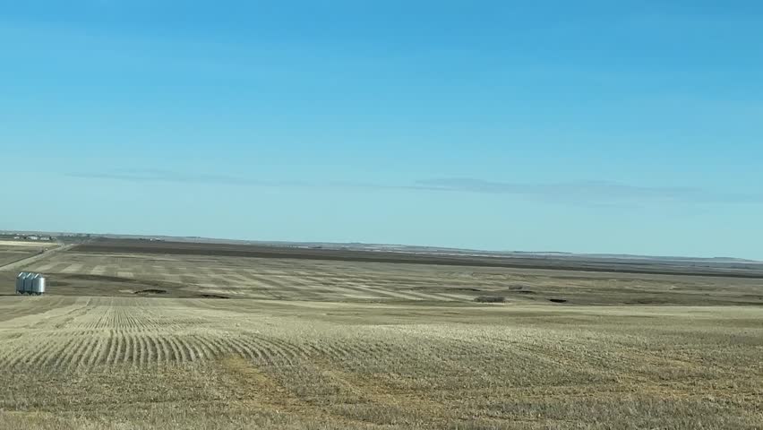 Point-of-view footage driving along a highway in rural Alberta, Canada. Captured for commercial use to illustrate transportation, travel, open roads, and Canadian scenery.