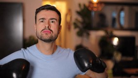 Funny man playing around with boxing gloves  - Powered by Shutterstock - Get 15% off with code: PIKWIZARD15