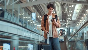 Happy asian man with backpack checking flight in phone on escalator in airport terminal, People concentrating typing digital device for travel in transportation, Concept of travel - Powered by Shutterstock - Get 15% off with code: PIKWIZARD15