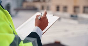 Person, civil engineer or hands writing with clipboard in city for architecture, inspection or industrial development. Closeup, contractor or building inspector with checklist for construction safety - Powered by Shutterstock - Get 15% off with code: PIKWIZARD15
