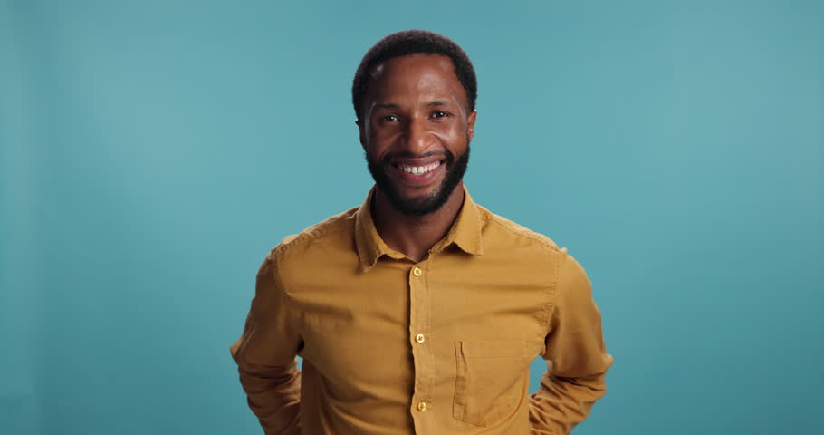 Fashion, laughing and face of black man in studio for meme, smile and confidence. Happy, joy and funny with person from Kenya on blue background for joke, cheerful and humor emoji with cool style