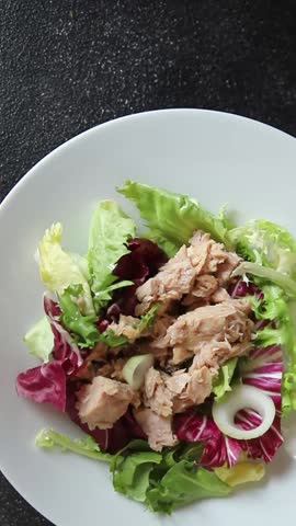Tuna salad canned fish mixed green leaf lettuce seafood appetizer vegetable dish organic fresh tasty gourmet food background on the table rustic top view copy space vegetarian food pescetarian diet