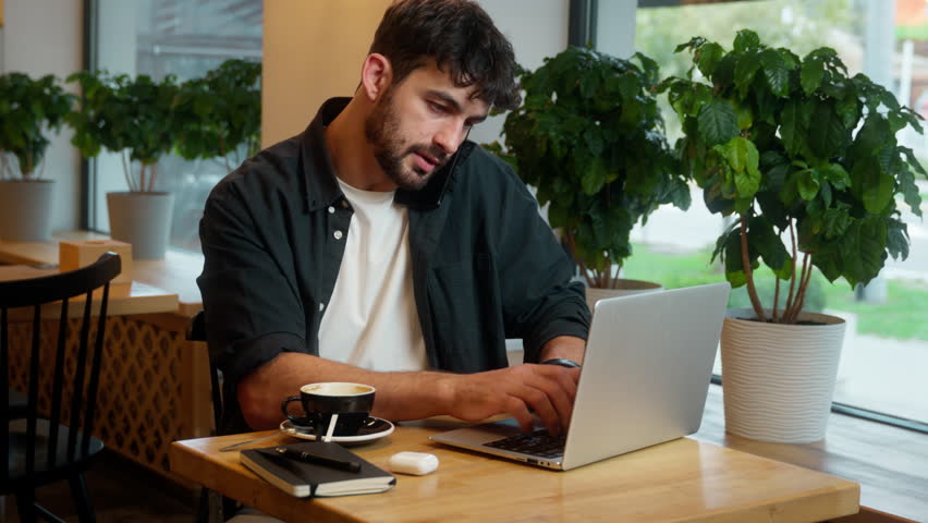 Caucasian man talking mobile phone cellphone call client order male businessman multitasking guy entrepreneur cafe laptop writing notes information notebook business indoor visitor smartphone employee - Powered by Shutterstock - Get 15% off with code: PIKWIZARD15