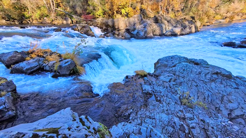 Vivid Blue River Rapids Cascading Over Rocks