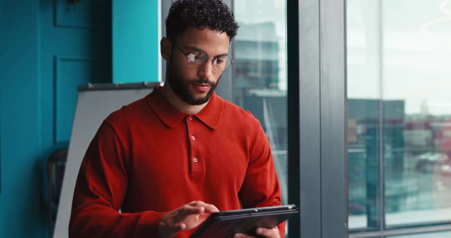Businessman, thinking or window with tablet for vision, company ambition or dream at office. Thoughtful man, employee or designer with reflection, smile or technology for business development or view