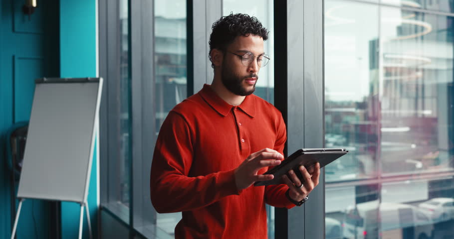 Businessman, thinking or window with tablet for vision, company ambition or dream at office. Thoughtful man, employee or designer with reflection, smile or technology for business development or view