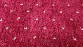 Close-up view of a plush, crimson carpet with a subtle pattern of beige dots. The texture is soft and the color is rich. - Powered by Shutterstock - Get 15% off with code: PIKWIZARD15