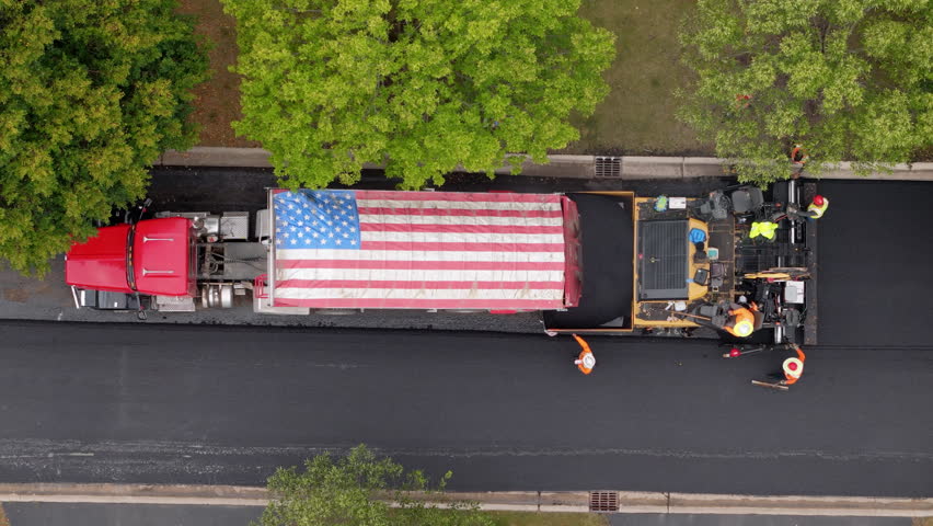 Roadwork development new asphalt road and real estate houses at Suburban. Aerial top down shot with usa national flag on it