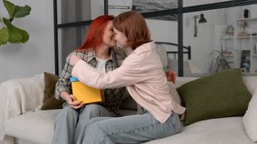 Joyful charming redhead mature mother receiving present , thanking for birthday gift and embracing loving cute teen daughter , expressing happiness and excitement n domestic room. - Powered by Shutterstock - Get 15% off with code: PIKWIZARD15