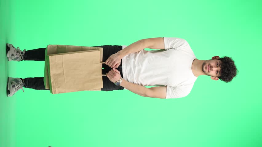 Man, on a green background, full-length, with bags
