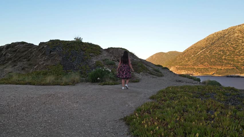 Aerial view of a girl amidst the stunning mountainous terrain of Crete, Greece. Surrounded by rugged cliffs and natural beauty, the scene captures a perfect blend of adventure and serenity.