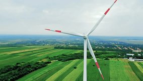 Wind Turbine Rotates in Beautiful Landscape - Renewable Energy. Wind turbines producing electricity. Investing in green energy projects. Wind turbine spinning smoothly at wind farm. - Powered by Shutterstock - Get 15% off with code: PIKWIZARD15