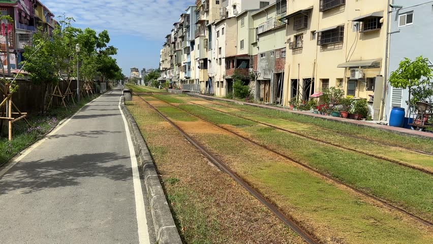 Kaohsiung city taiwan trams train tracks railway line buildings sunny day
