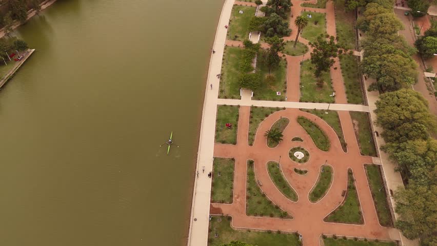 Parque General San Martin, rower training on lake, park paths, Mendoza, Argentina. Aerial top-down forward
