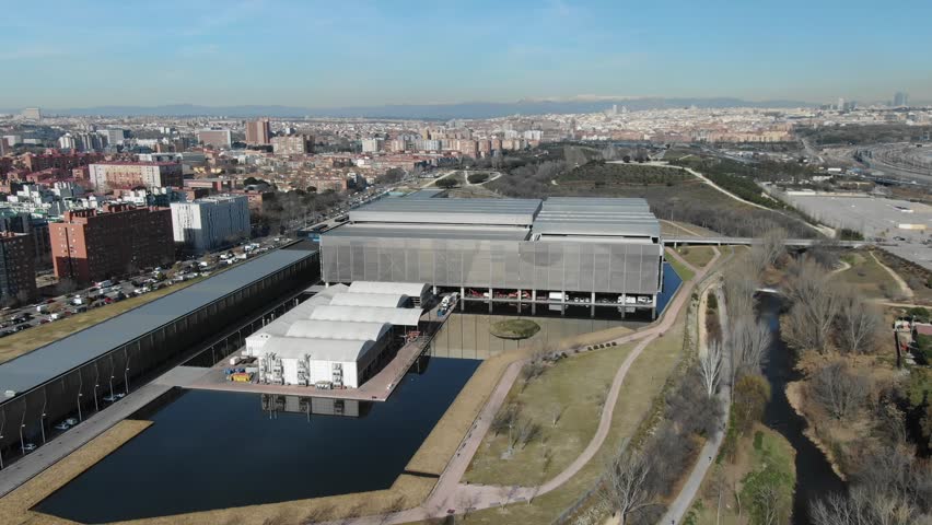 Caja Mágica multi-purpose stadium complex, Manzanares Park Tennis Center, Madrid in cityscape. Aerial drone