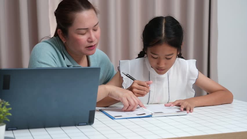Asian girl asks her mom for help with homework after school