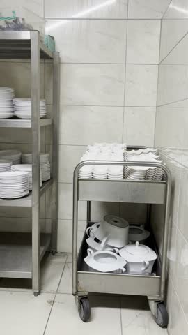 Industrial kitchen or pantry storage with metal shelves and white containers.