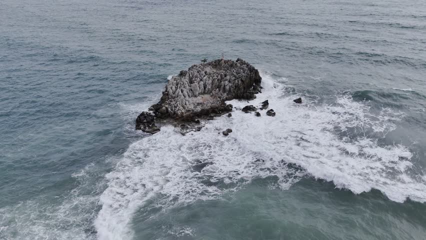 a small rocky island in the sea. High quality 4k footage