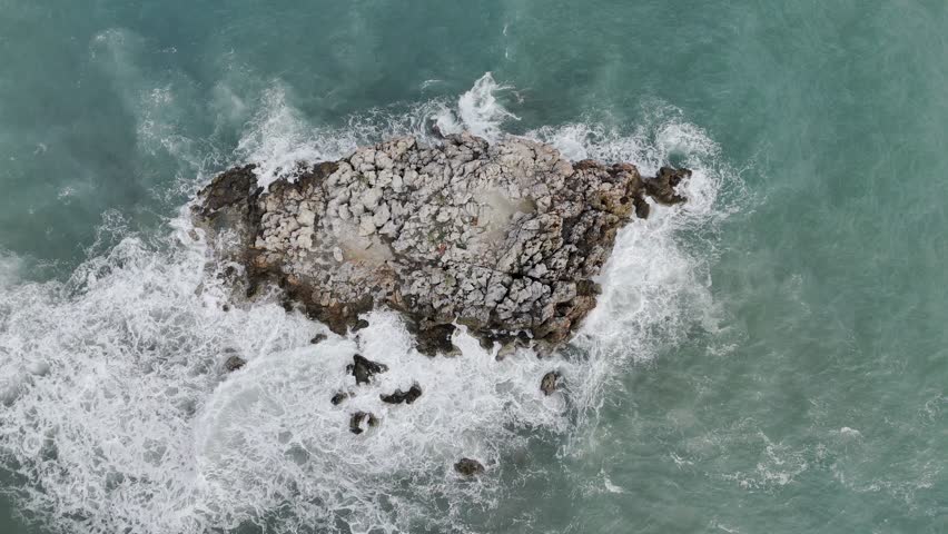 a small rocky island in the sea. High quality 4k footage