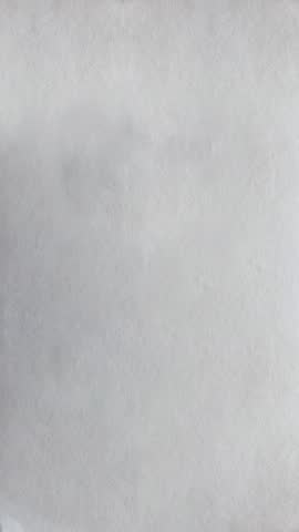 A piece of paper folds in a smooth motion on a green screen. The fold lines are clearly visible, giving a realistic texture to the paper.