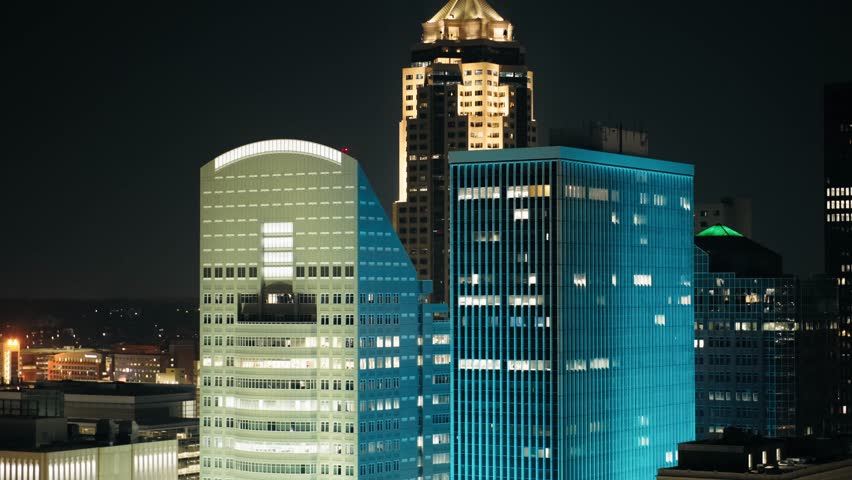 A smooth flyover of downtown Des Moines, capturing the glowing skyline and city grid at night.