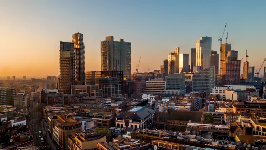Night to day sunrise time lapse view of the skyline at the City of London, England, from a unique viewpoint in the north