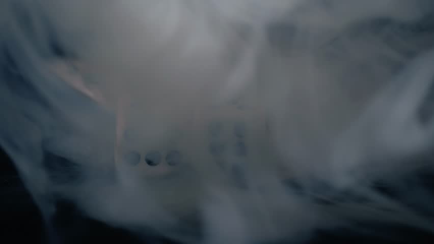Smoke clears to reveal dice close up macro dolly 4k shot selective focus