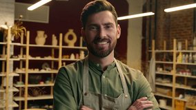 Confident successful joyful professional Caucasian guy salesman potter male man businessman happy smiling artist small business owner looking at camera crossing hands gesture indoors workshop pottery - Powered by Shutterstock - Get 15% off with code: PIKWIZARD15