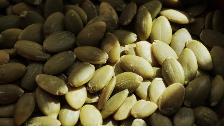 Healthy organic pumpkin seeds close-up. Healthy vegetarian snack. High quality 4k footage