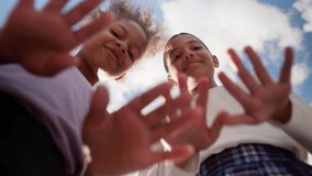 Happy children girls friends sisters schoolgirls pupils little students African American Latina kids fun game outdoors city playing together bottom view moving hands dancing school education studying - Powered by Shutterstock - Get 15% off with code: PIKWIZARD15