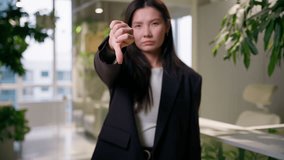 Bad result feedback negative sign displeased sad Asian business woman Chinese Korean Japanese girl businesswoman student employee manager worker in office thumb down no dislike gesture problem fail - Powered by Shutterstock - Get 15% off with code: PIKWIZARD15