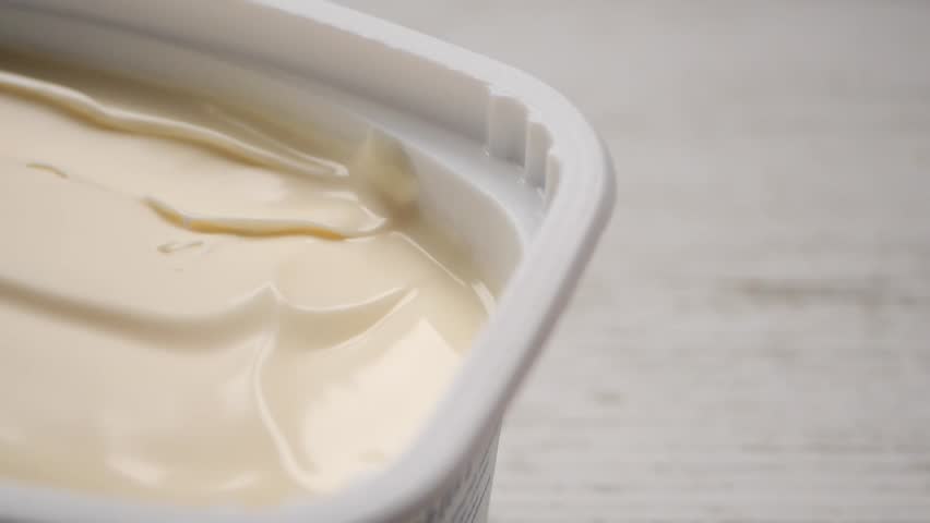 Butter spread in container on a table 