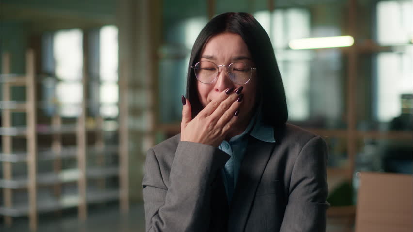 Tired sleepy sad Asian business woman Chinese Korean Japanese exhausted female businesswoman industrial engineer architect yawning fatigue overworked in office lack of sleeping low energy morning work
