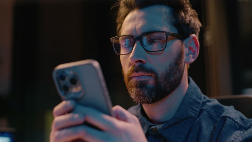 Caucasian man business entrepreneur manager at dark night evening office overtime working male guy concentrated businessman ceo trader browsing smartphone gadget addict insomnia typing mobile phone