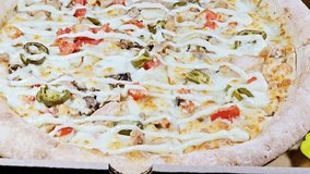 Jalapeno Chicken pizza with slices chicken pieces chunks, mozzarella cheese, olive oil, fresh herbs, chili pepper slices, tomato sauce, Italian cuisine pizza, selective focus - Powered by Shutterstock - Get 15% off with code: PIKWIZARD15