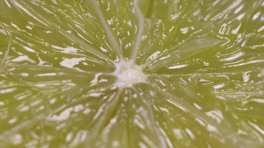 Fresh lemon being squeezed to release its tangy juice, perfect for adding a burst of citrus flavor to any dish or drink.