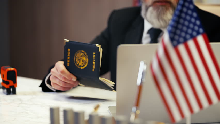 U.S. embassy worker places denied stamp in Mexican womans passport, visa refusal