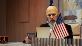 Embassy employee processing U.S. passport data on laptop, consular record check - Powered by Shutterstock - Get 15% off with code: PIKWIZARD15