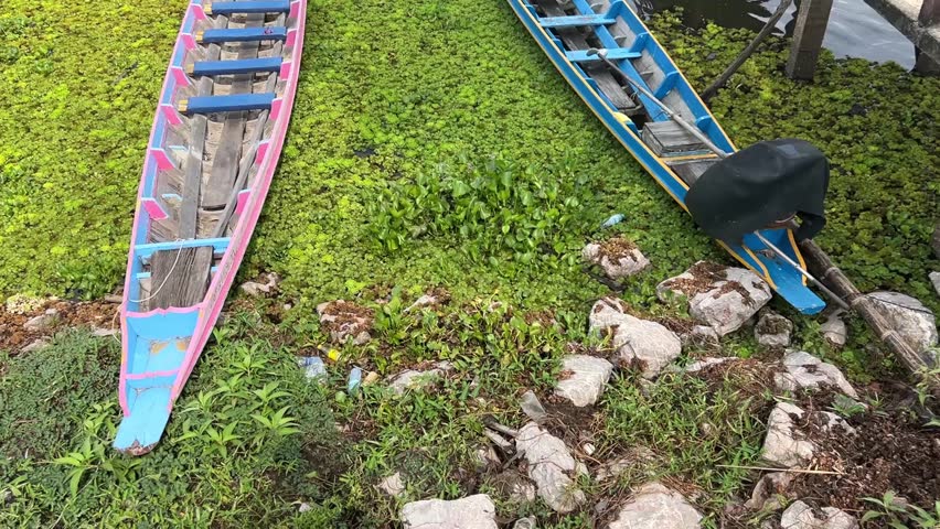 Small boats of local people parked on a large river in Thailand