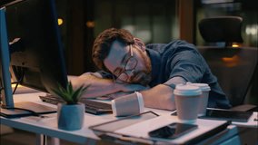 Caucasian guy sleeping tired businessman sleep nap at dark night office lost health problem insomnia overtime male business man workaholic overworked exhausted awake stressed typing computer deadline - Powered by Shutterstock - Get 15% off with code: PIKWIZARD15