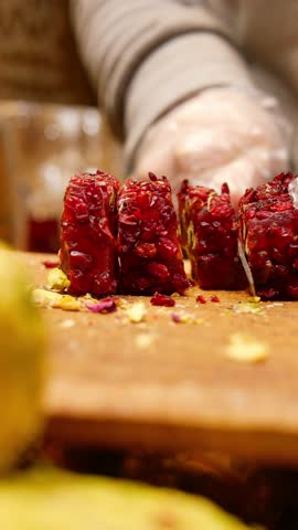 cutting Turkish traditional sweet Turkish delight on a chopping board 