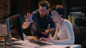 Caucasian business man woman co-workers teamwork at evening night office girl guy working together commerce bitcoin trading computer professional mentor coach consult help businessman businesswoman - Powered by Shutterstock - Get 15% off with code: PIKWIZARD15